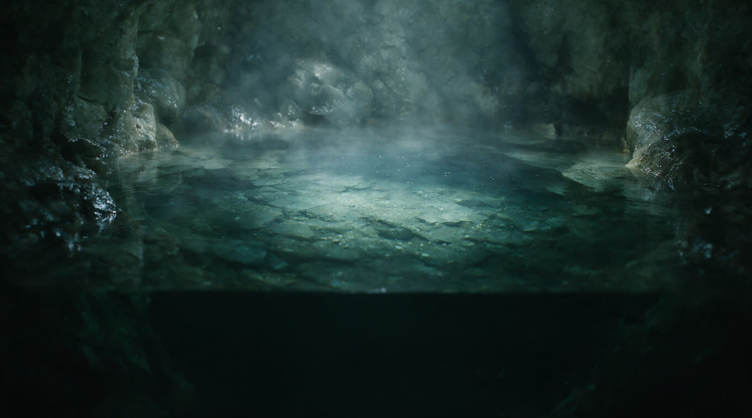 Clear groundwater standing in a pale rock chamber